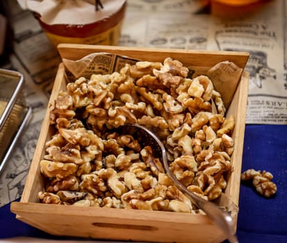 Lots of walnut kernels in a wooden box on a buffet.