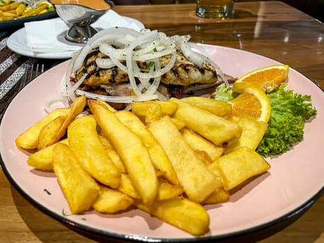A plate of grilled meat and fries on a plate.