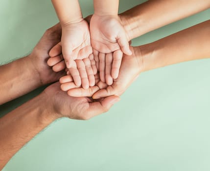 Top view parents and little kid holding empty hands together studio shot isolated on green background, family home, hands children on adult mother hand, help support, parents family day concept