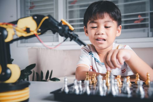 Asian little boy is playing chess with robot machine arm, STEM education E-learning, Funny children learning successful getting a lesson control robot arm, Technology science education concept