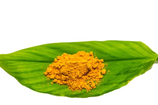 turmeric powder on a fresh green turmeric leaf