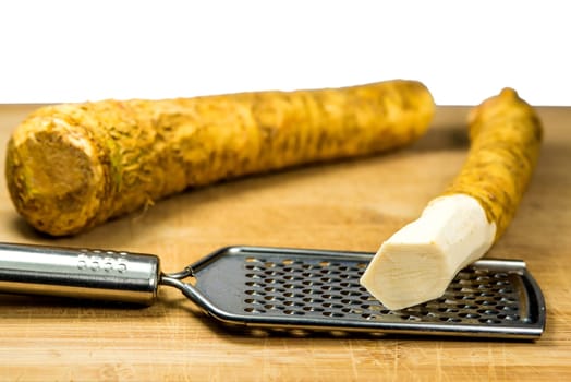 horseradish, whole piece and peeled piece on grater