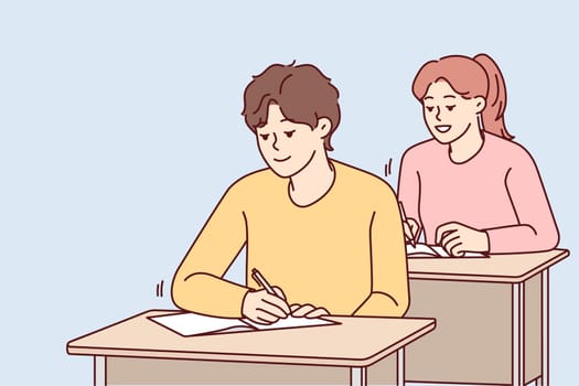 Smiling students sit at desk writing in notebooks on lesson in school. Happy pupils handwriting at class. Education and learning. Vector illustration.