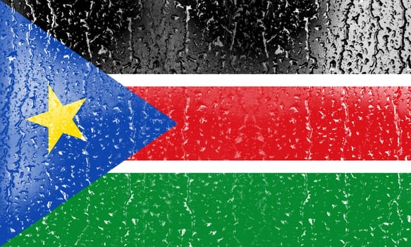 3D Flag of South Sudan on a glass with water drop background.