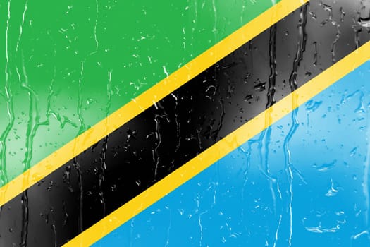 3D Flag of Tanzania on a glass with water drop background.