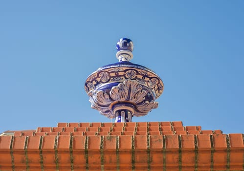 Ceramic top vase placed over brick wall. Espronceda Square, Almendralejo, Badajoz, Spain