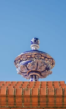 Ceramic top vase placed over brick wall. Espronceda Square, Almendralejo, Badajoz, Spain