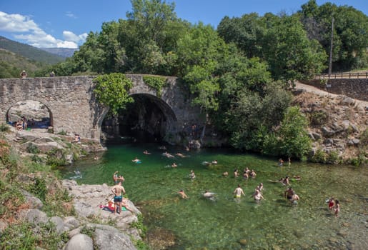 Losar, Spain - August 23th, 2022: Cuartos natural swimming pool. Crystal-clear waters spot in the heart of La Vera County, Caceres, Extremadura, Spain