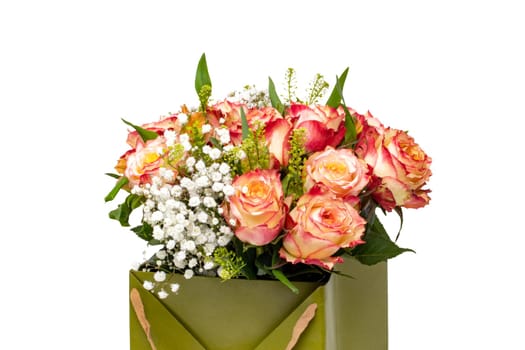 Closeup of a beautiful bouquet of red yellow roses in a decorative green gift box isolated on a white background. Clipping path. Macro.