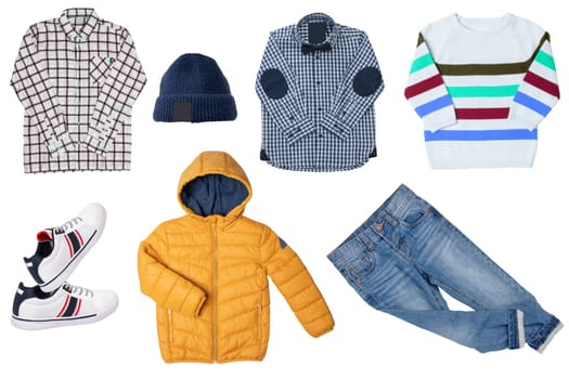 Collage set of little boys autumn clothes isolated on a white background. Denim trousers or pants, sneaker, a rain jacket, shirts and a cap for child boy. Children's spring fashion.