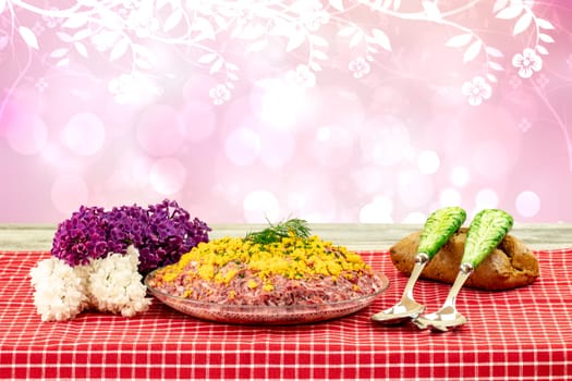 Traditional russian layered salad named herring under a fur coat. Traditional Russian cusine on a rustic table over abstracrt flower background. Concept Russian food. Space.