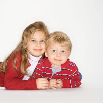 Studio portrait of Caucasian boy and girl against white background.
