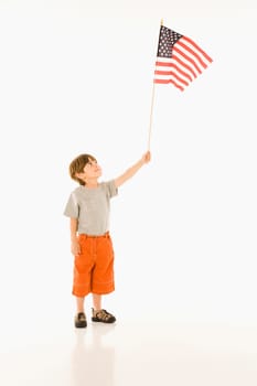 Boy holding American flag against white background.