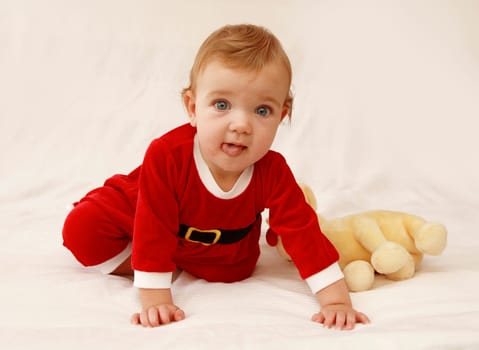 Baby dressed in red like a little santa.