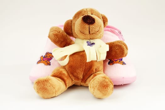 Teddy and baby shoes on bright background