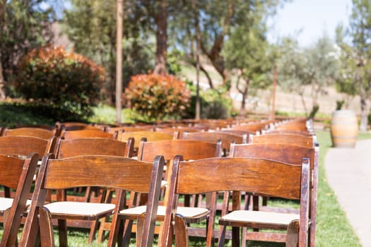 Rows of Wooden Event Chairs at Wedding Venue Abstract.