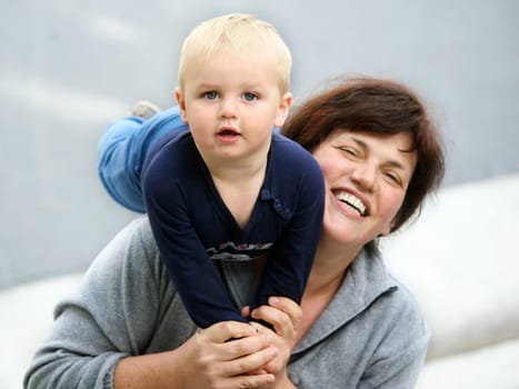 Happy Mother lifting her 14 month old baby