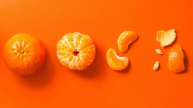 Tangerines on an orange background: whole, peeled, wedges and peels. Flat lay, banner