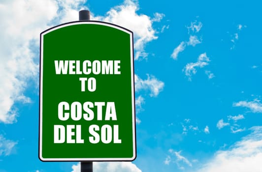 Green road sign with greeting message WELCOME TO COSTA DEL SOL isolated over clear blue sky background with available copy space. Travel destination concept  image