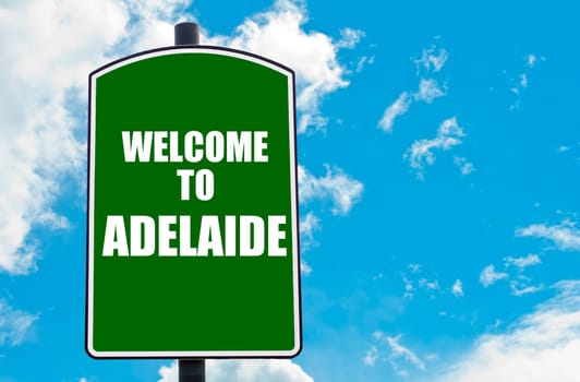 Green road sign with greeting message WELCOME TO ADELAIDE, AUSTRALIA isolated over clear blue sky background with available copy space. Travel destination concept  image