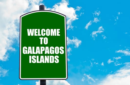 Green road sign with greeting message WELCOME TO GALAPAGOS ISLANDS isolated over clear blue sky background with available copy space. Travel destination concept  image