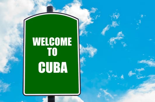 Green road sign with greeting message WELCOME TO CUBA isolated over clear blue sky background with available copy space. Travel destination concept  image