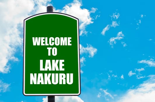 Green road sign with greeting message WELCOME TO LAKE NAKURU isolated over clear blue sky background with available copy space. Travel destination concept  image