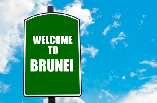 Green road sign with greeting message WELCOME TO BRUNEI isolated over clear blue sky background with available copy space. Travel destination concept  image