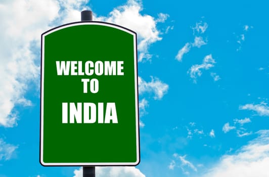 Green road sign with greeting message WELCOME TO INDIA isolated over clear blue sky background with available copy space. Travel destination concept  image