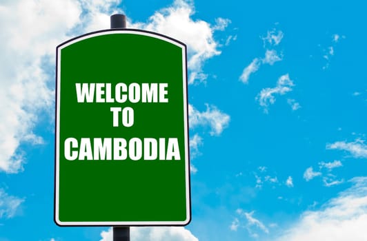 Green road sign with greeting message WELCOME TO CAMBODIA isolated over clear blue sky background with available copy space. Travel destination concept  image