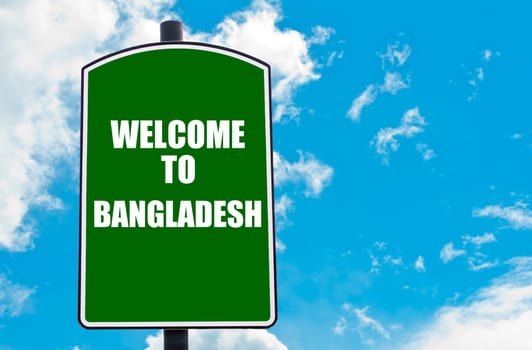 Green road sign with greeting message WELCOME TO BANGLADESH isolated over clear blue sky background with available copy space. Travel destination concept  image
