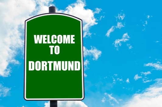 Green road sign with greeting message WELCOME TO DORTMUND, GERMANY isolated over clear blue sky background with available copy space. Travel destination concept  image