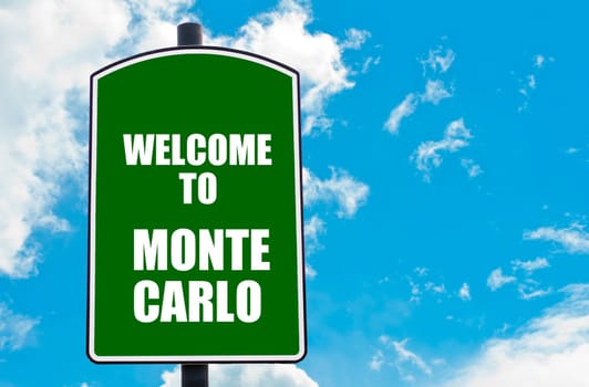 Green road sign with greeting message WELCOME TO MONTE CARLO isolated over clear blue sky background with available copy space. Travel destination concept  image