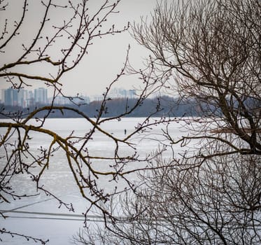 Concept shot of the man fishing on the frozen lake