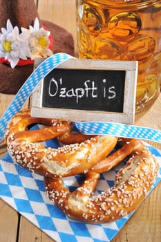 original Bavarian laugenbrezeln with Oktoberfest beer mug and traditional hat