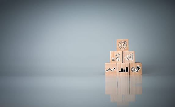 Wood cube block stacking with icon.Concept of business strategy and goal action plan.