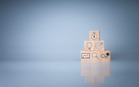 Wood cube block stacking with icon.Concept of business strategy and goal action plan.