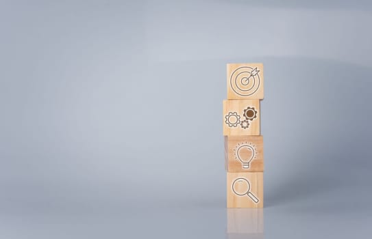 Wood cube block stacking with icon.Concept of business strategy and goal action plan.