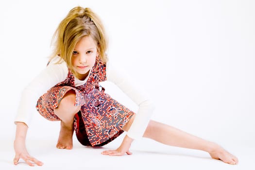 Studio portrait of a blond child stretching