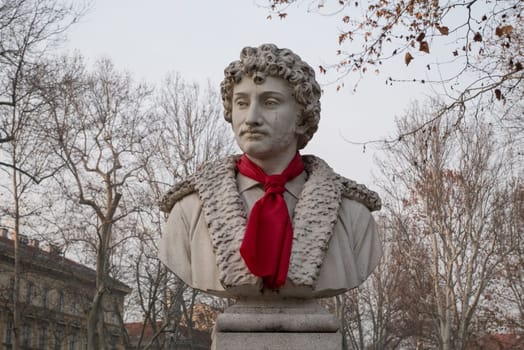 ZAGREB, CROATIA-January 4, 2020: Park Zrinjevac, sculpture of Croatian painter Andrija Medulic with red tie. Scripture is the work of sculptor Ivan Meštrovic.