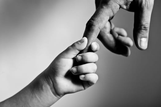 child hand hold by the adult hand
