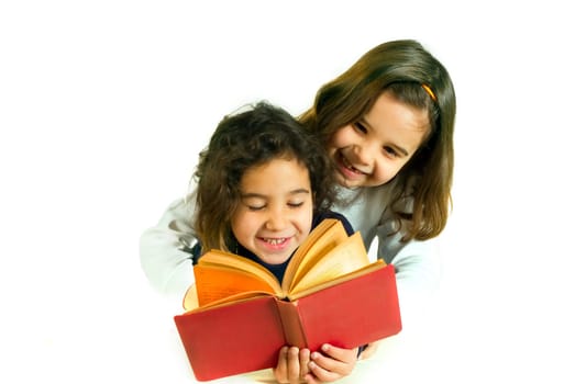 two girls reading book isolated on white