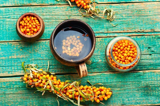 Fragrant autumn tea, medicinal tea with fresh sea buckthorn. Berry drink