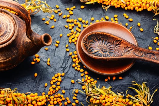 Fragrant autumn tea, medicinal tea with fresh sea buckthorn. Berry drink