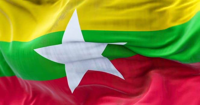 Close-up view of Myanmar national flag waving. The Republic of the Union of Myanmar is a State of Southeast Asia. Fabric textured background. Selective focus. 3D illustration render