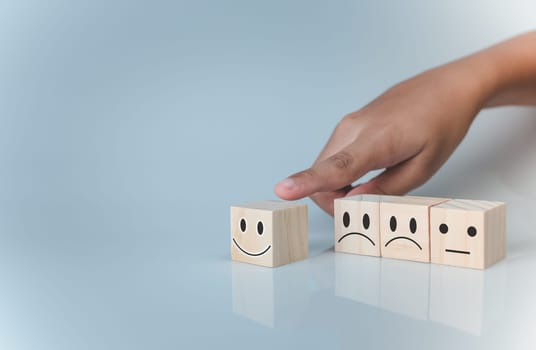 Hand choosing happy smile icon. represents feedback rating and positive customer review, Satisfaction Concept, satisfaction survey ,mental health assessment, world mental health day, think positive concept