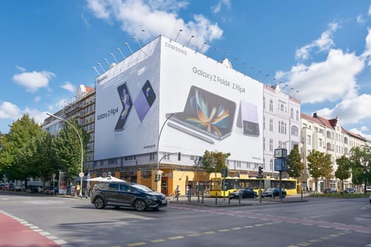 Street scene on Kantstrasse in Berlin. In the background at a construction site advertising for a smartphone.