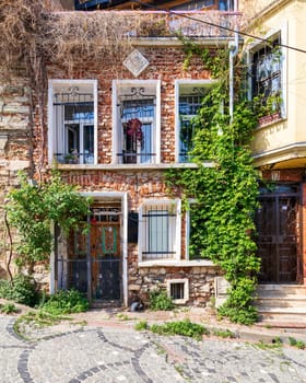 Beautiful old traditional red bricks houses in old Balat district, on a summer day, Istanbul, Turkey