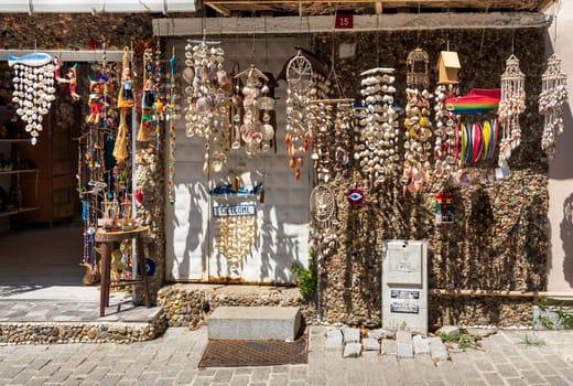 Storefront of souvenir store, with hanged handmade crafts made of sea shells, suited in Anadolu Kavagi district, Istanbul, Turkey
