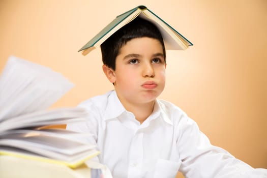 little boy getting bored of doing homeworks